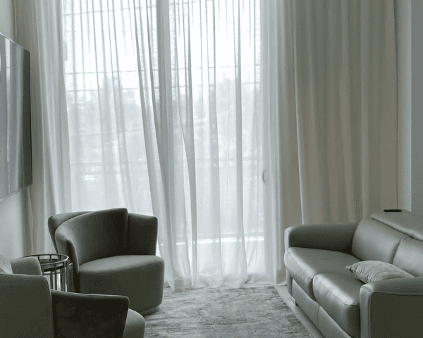 Transparent white drapery installed in a living room
