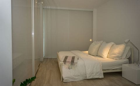 White blackout shades with side channels that block lights from the side of the blind