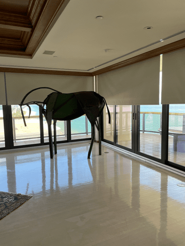 Blackout Shades motorized installed on sliding door windows in an living room ocean front