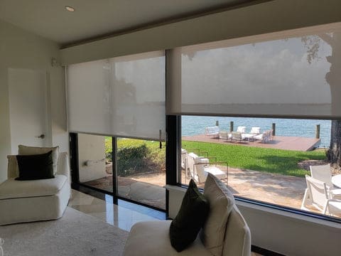 White roller solar shades for a beach house