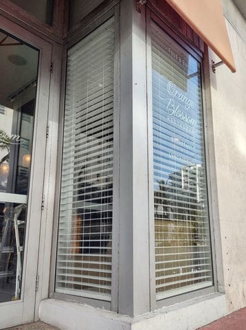 Front of a restaurant with faux wood blinds 