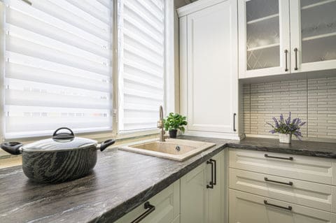 Zebra blinds light filtering over the sink