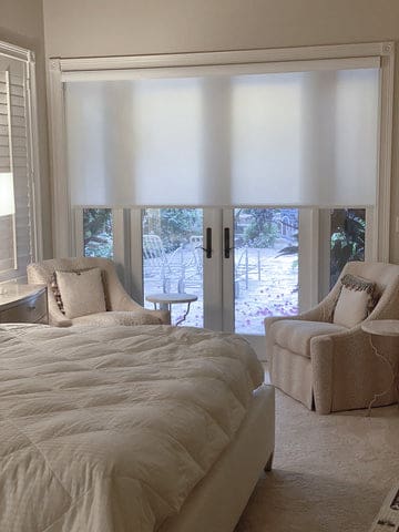 light-filtering shades installed in glass-door in a bedroom