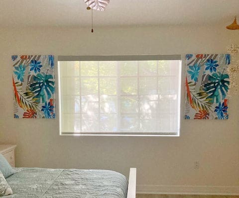 Window blinds rental property. White solar shades in bedroom window