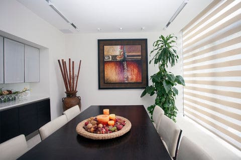 white linen zebra blinds in a dinin room with long brown table