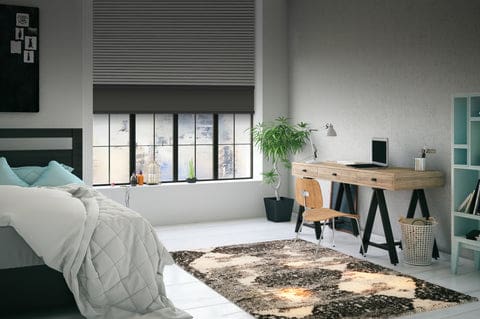 Bedroom with grey double roller shades installed