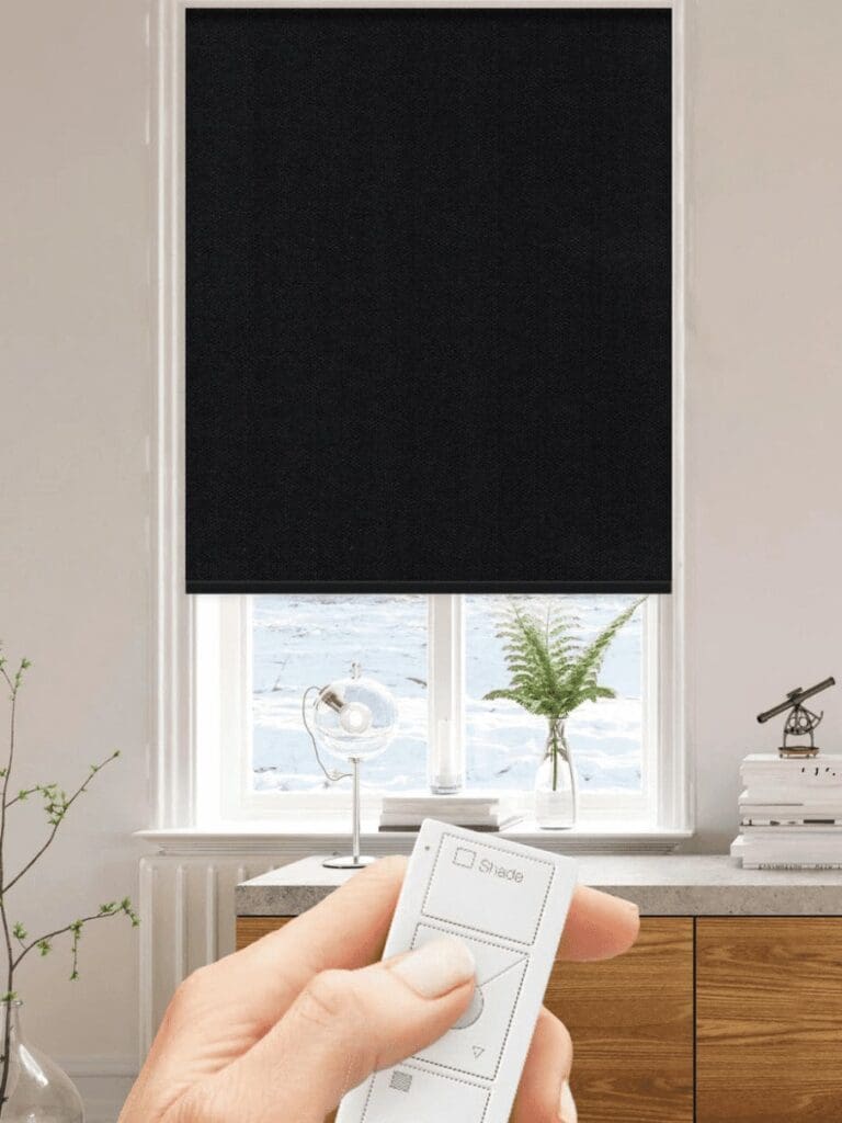 Blackout motorized window shades in black.