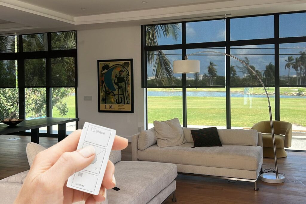 Black motorized solar roller shades in living room.